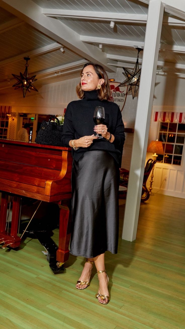 Black turtleneck sweater with a black satin midi skirt