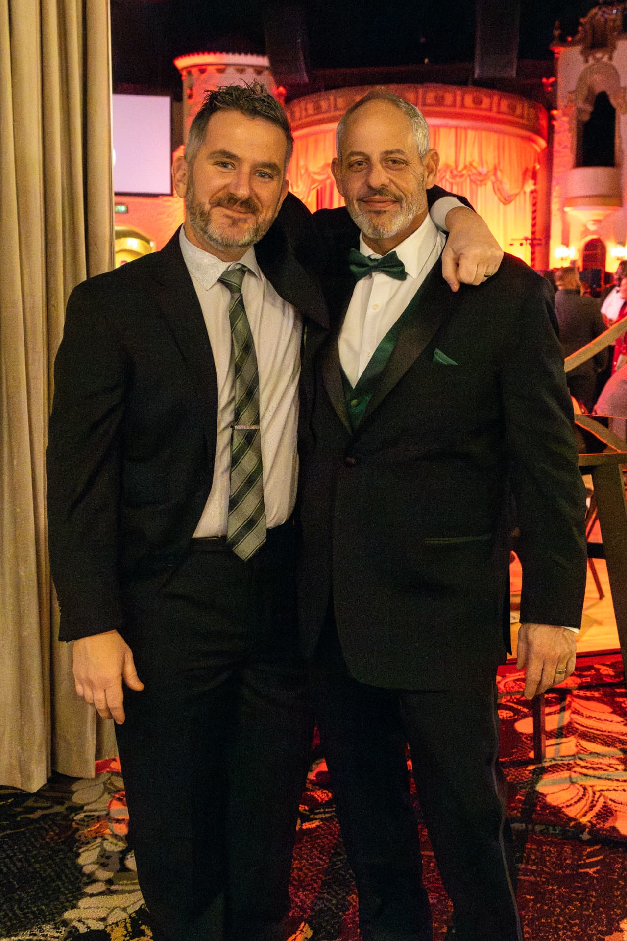 Dan and Steve in cocktail attire at the 2026 holiday party